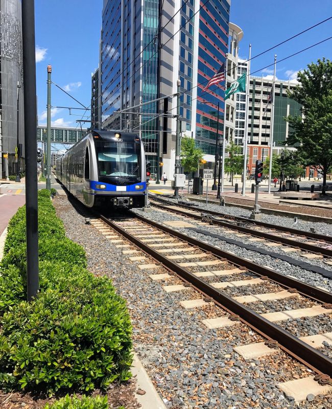 Silver line light rail on tracks through Charlotte, NC